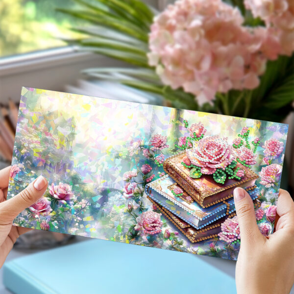 Wenskaart met boekstapel en bloemen in parelmoer steentjes